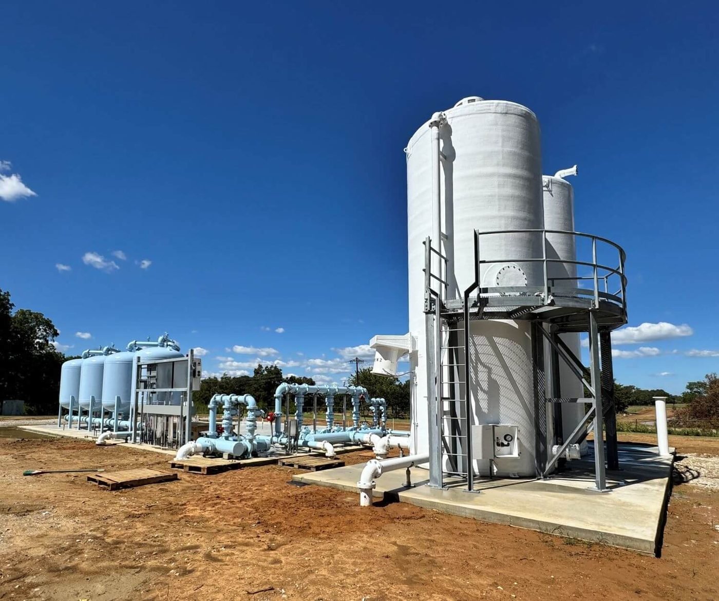 Ground aerators at grade beside a row of pressure filters