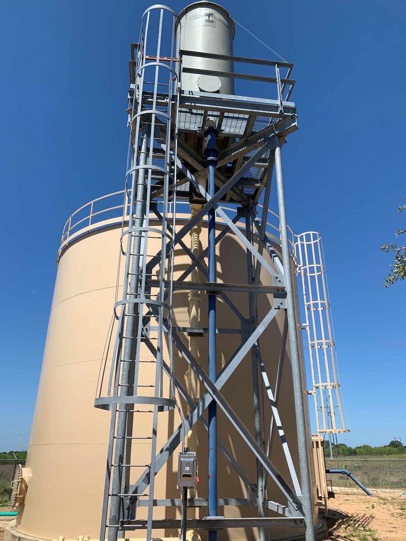 WETS elevated aerator mounted above a ground storage tank