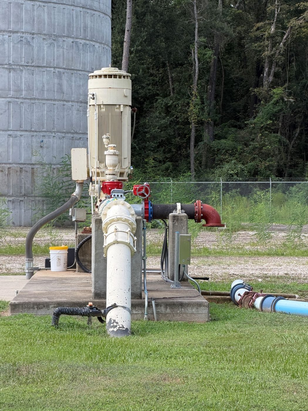 Vertical turbine pump and discharge piping beside a ground storage tank at a WETS aerator rehabilitation site