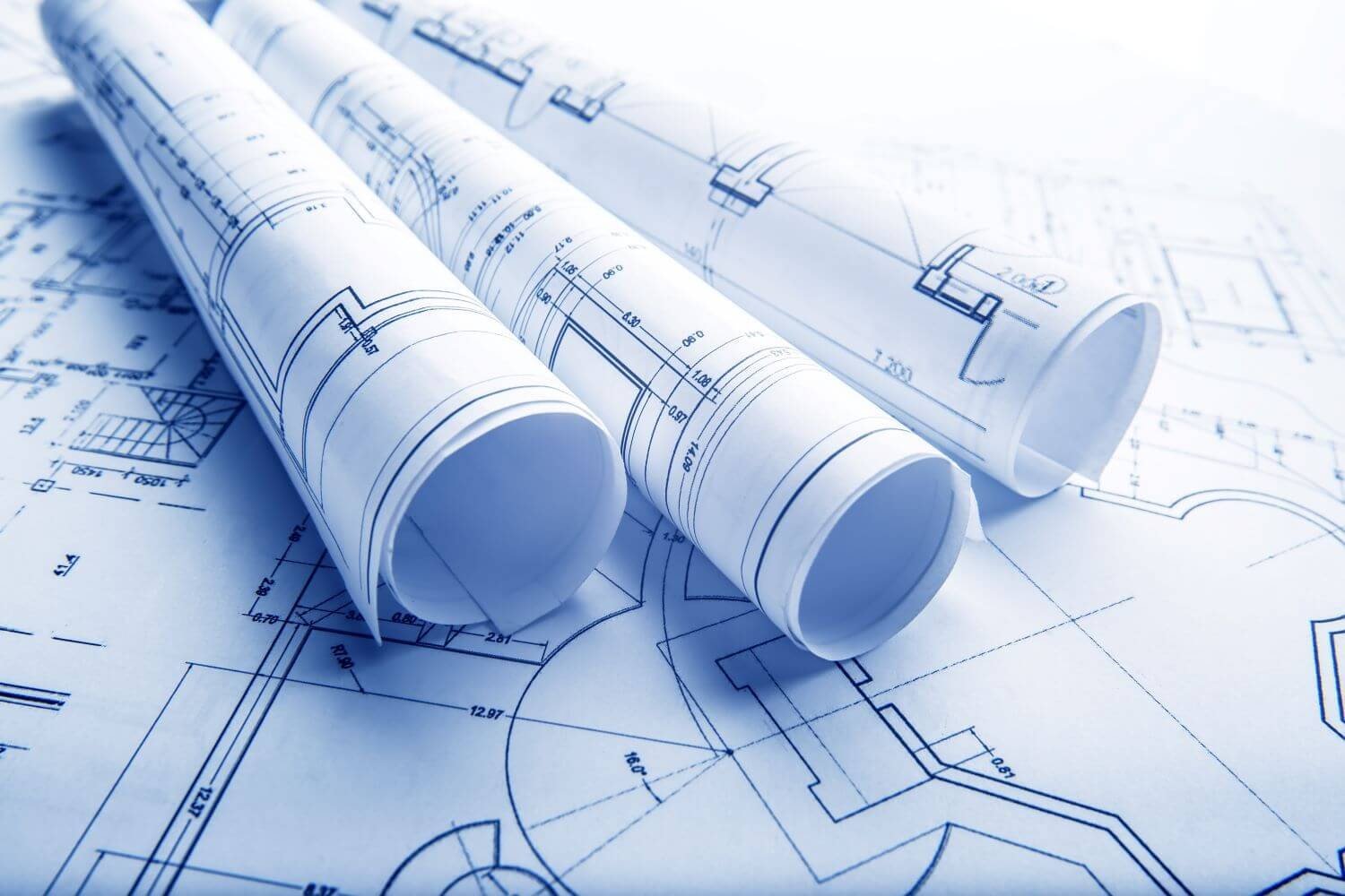 Rolled structural engineering drawings on a drafting table