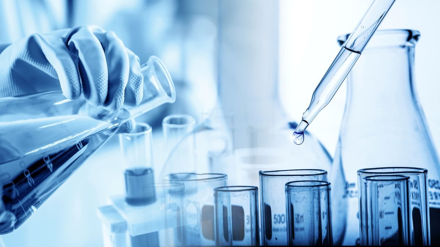 Laboratory glassware and pipette during water quality analysis